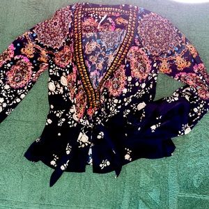 Beautiful silky FreePeople blouse. Black background multicolor